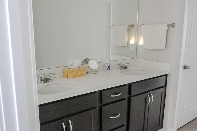 full bathroom with double vanity and a sink