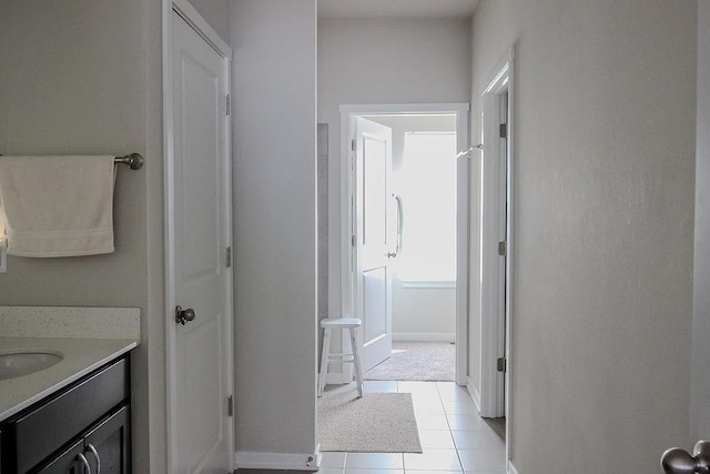 bathroom featuring tile patterned flooring, vanity, and baseboards