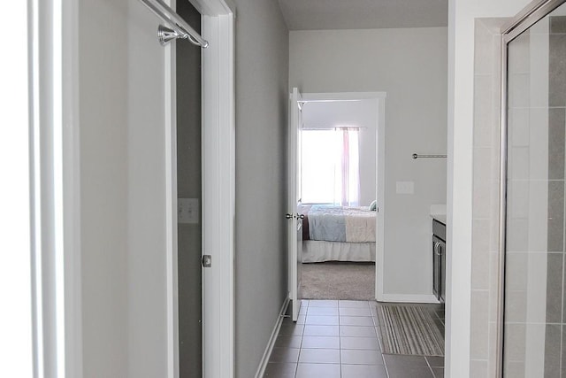 bathroom featuring a stall shower, vanity, ensuite bath, tile patterned flooring, and baseboards