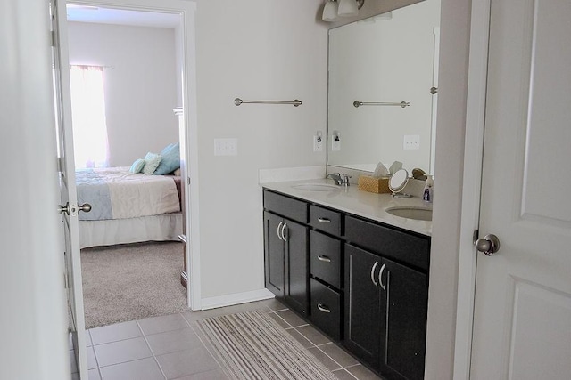 ensuite bathroom featuring tile patterned flooring, a sink, ensuite bath, and double vanity