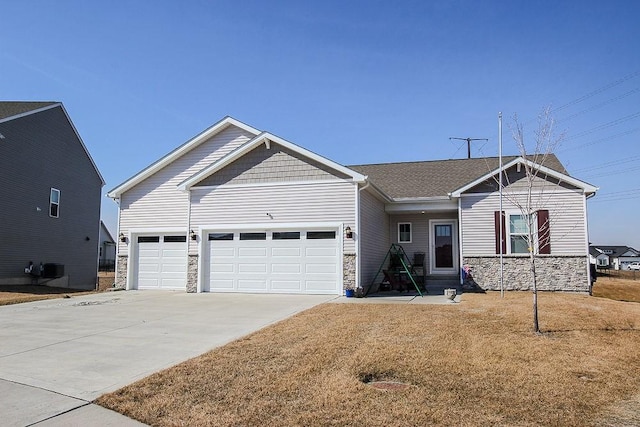 view of front of property with stone siding, concrete driveway, and an attached garage