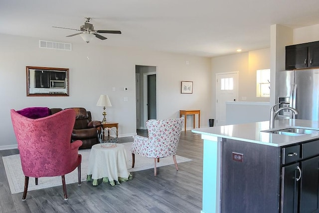 kitchen featuring light countertops, visible vents, appliances with stainless steel finishes, a sink, and wood finished floors