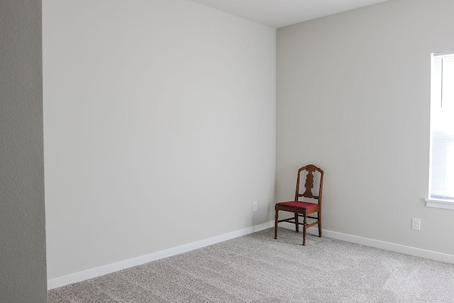 sitting room with light carpet and baseboards