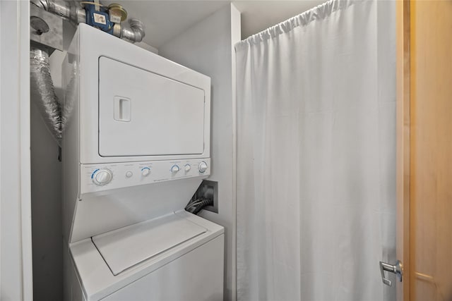 clothes washing area with laundry area and stacked washer and clothes dryer