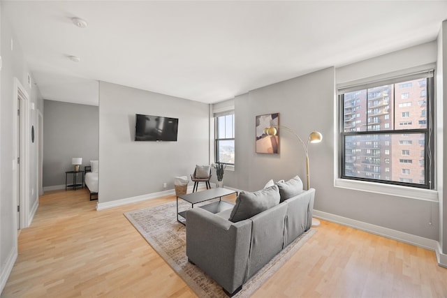 living room featuring light wood-style flooring and baseboards