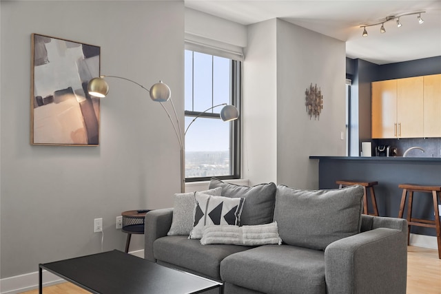 living room with light wood-style floors and baseboards