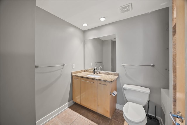 bathroom with visible vents, toilet, vanity, tile patterned flooring, and baseboards