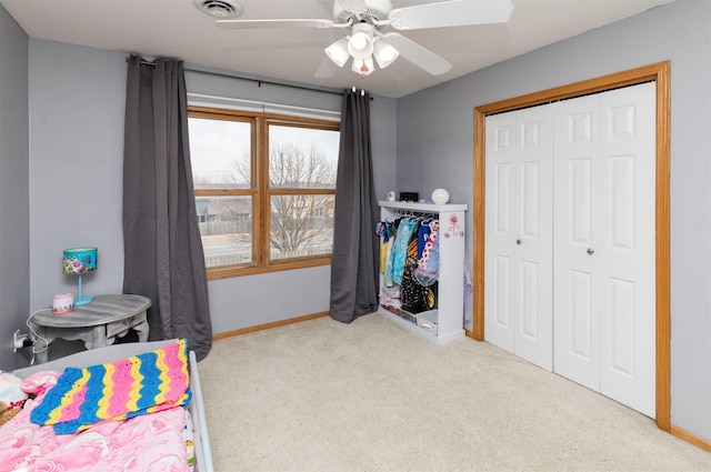 carpeted bedroom with a closet, visible vents, ceiling fan, and baseboards