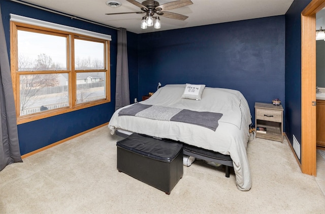 bedroom with carpet, visible vents, baseboards, and a ceiling fan