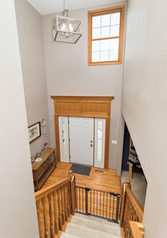 entrance foyer with visible vents and a chandelier