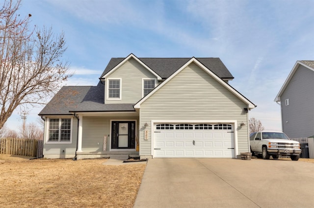 traditional-style house featuring a porch, concrete driveway, fence, and an attached garage