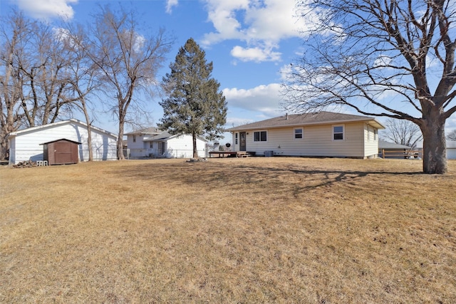 view of yard with a storage shed and an outbuilding