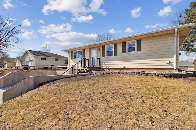 ranch-style house featuring a front yard and fence