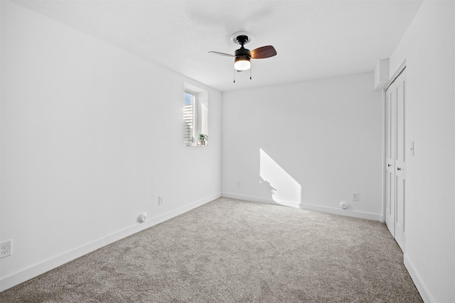 interior space featuring baseboards, a ceiling fan, and carpet