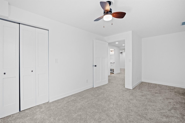 unfurnished bedroom featuring a closet, visible vents, baseboards, and carpet