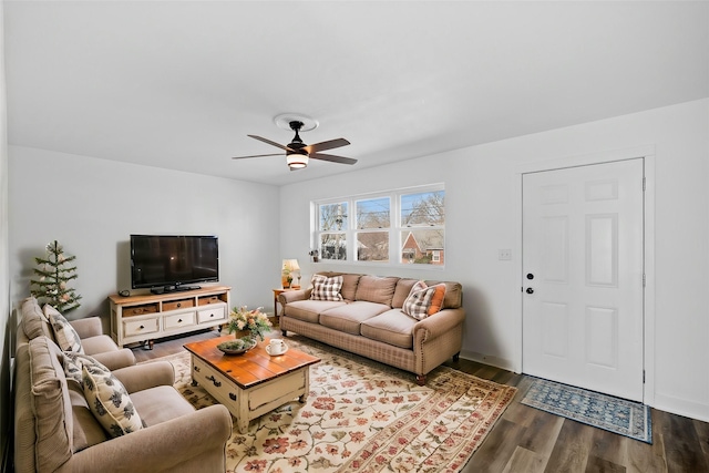 living area featuring wood finished floors and a ceiling fan