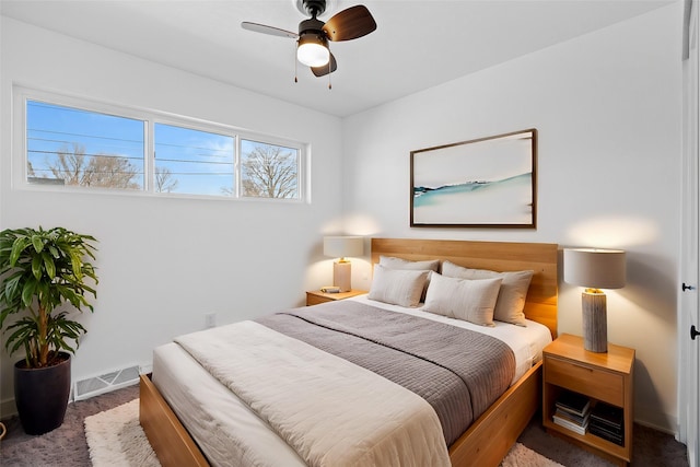 bedroom featuring visible vents, baseboards, carpet, and a ceiling fan