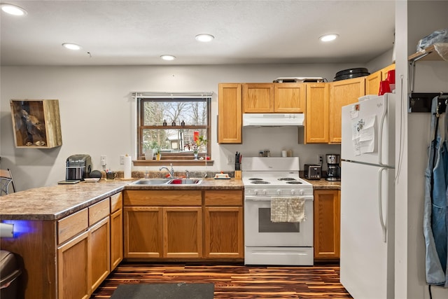 kitchen featuring recessed lighting, under cabinet range hood, a peninsula, white appliances, and a sink