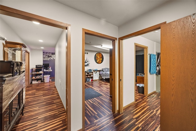 hall with wood finished floors and recessed lighting