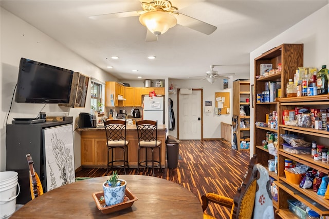 dining room featuring dark wood-style floors, a ceiling fan, and recessed lighting