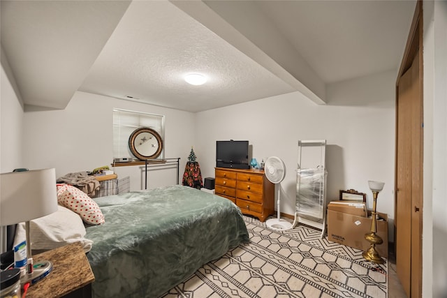 bedroom with baseboards and a textured ceiling