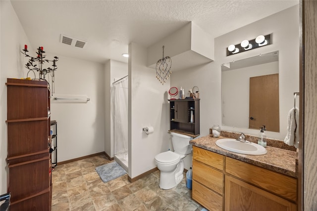 bathroom featuring visible vents, a shower with shower curtain, toilet, a textured ceiling, and vanity