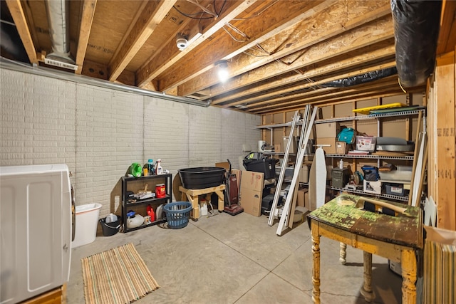 unfinished basement featuring washer / dryer