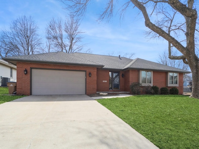 ranch-style house with central air condition unit, an attached garage, a front lawn, and brick siding