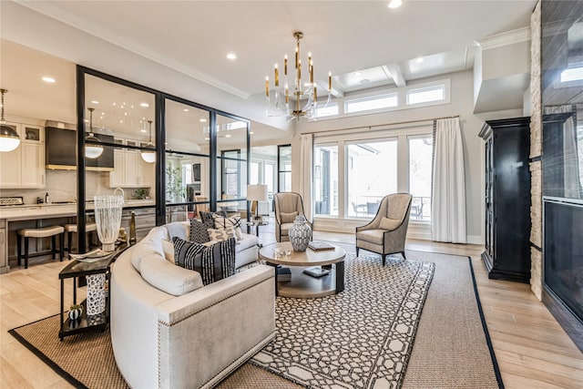 living area featuring ornamental molding, light wood-type flooring, recessed lighting, and an inviting chandelier