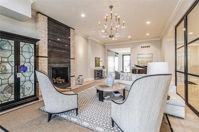 living area featuring ornamental molding, a fireplace, wood finished floors, and visible vents