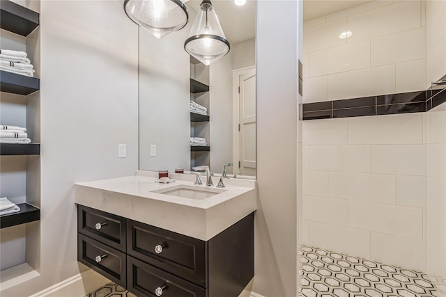 full bath featuring a tile shower and vanity