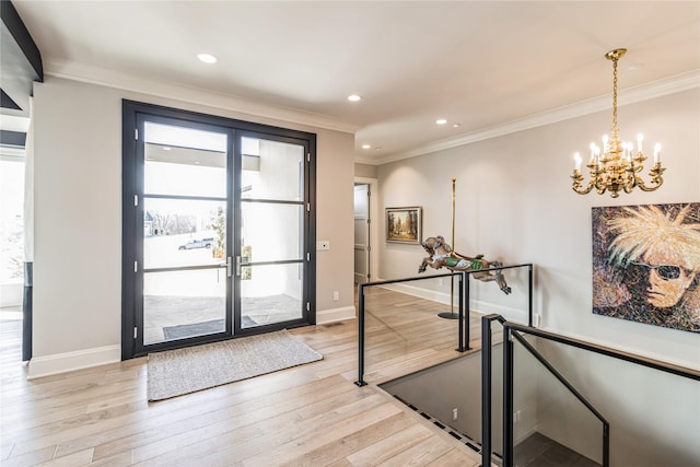 foyer entrance featuring ornamental molding, french doors, light wood-style flooring, and baseboards