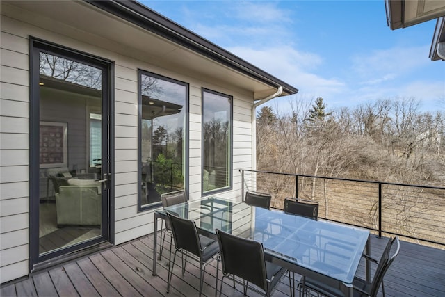 wooden terrace featuring outdoor dining area