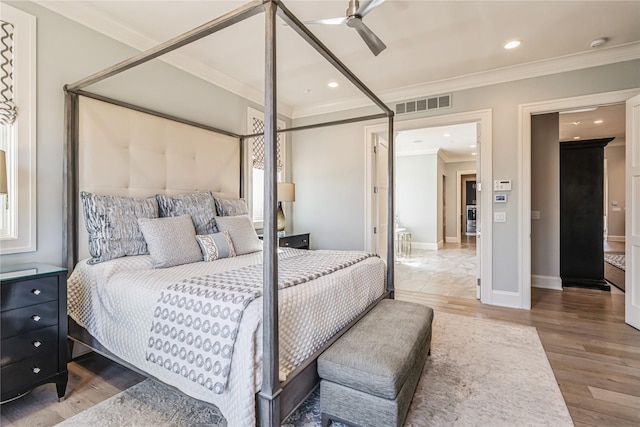 bedroom with crown molding, recessed lighting, visible vents, wood finished floors, and baseboards