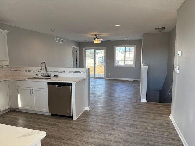 kitchen with light countertops, visible vents, open floor plan, a sink, and dishwasher