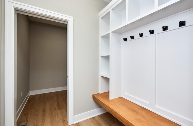 mudroom with wood finished floors and baseboards