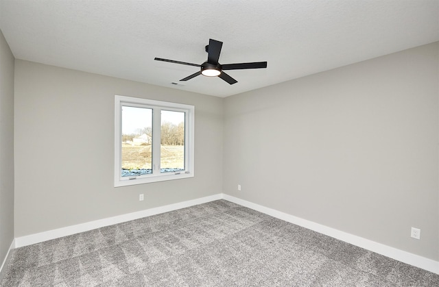 carpeted empty room featuring visible vents, baseboards, ceiling fan, and a textured ceiling