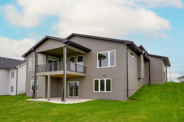 rear view of property with a patio area, a yard, and a balcony