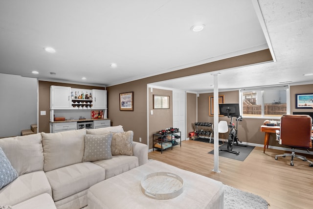 living area with beverage cooler, recessed lighting, light wood-style floors, baseboards, and a dry bar