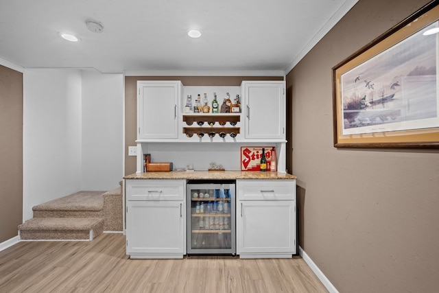 bar featuring baseboards, wine cooler, a dry bar, light wood-type flooring, and recessed lighting