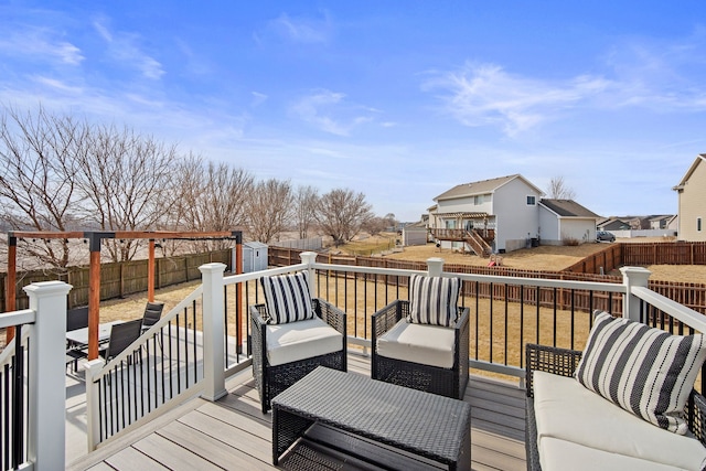 wooden terrace with a residential view, an outdoor hangout area, a storage shed, a fenced backyard, and an outbuilding