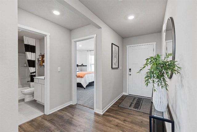 foyer featuring recessed lighting, wood finished floors, and baseboards