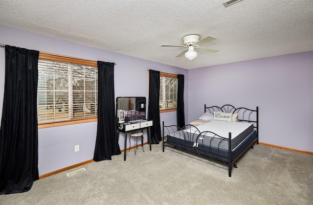 bedroom featuring multiple windows, carpet, visible vents, and baseboards