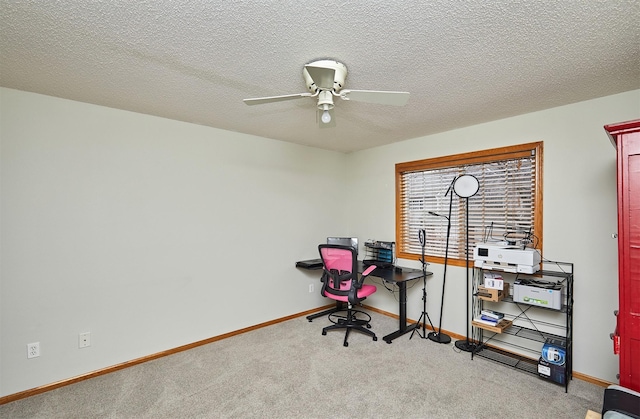 home office featuring carpet floors, baseboards, and a textured ceiling