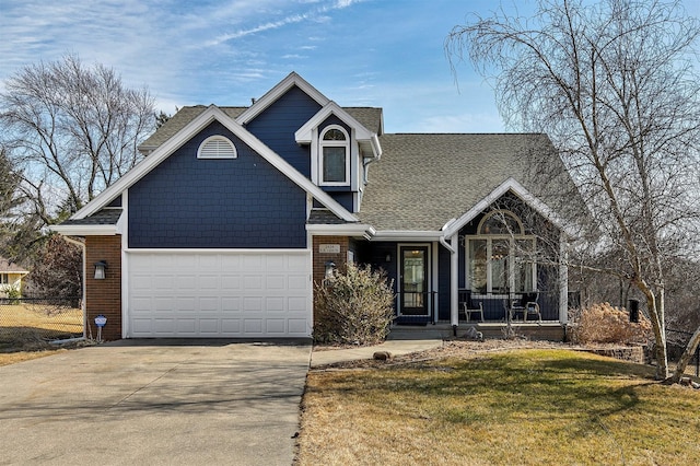 view of front of house featuring a porch, a garage, brick siding, concrete driveway, and a front lawn