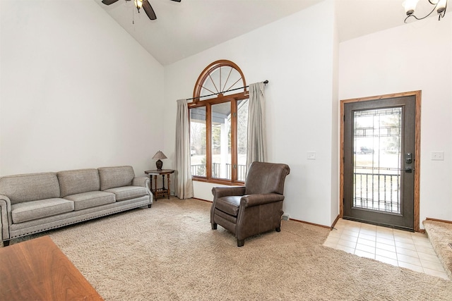 tiled living area featuring ceiling fan, high vaulted ceiling, and carpet flooring