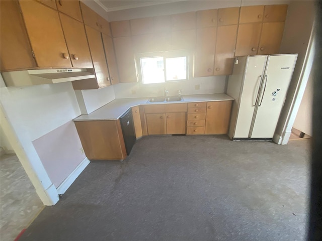 kitchen featuring light countertops, a sink, freestanding refrigerator, and dishwashing machine