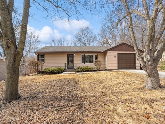 ranch-style home featuring an attached garage, board and batten siding, and concrete driveway