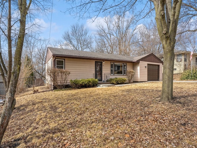 ranch-style home featuring an attached garage and fence