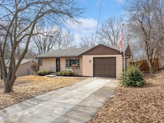 single story home featuring board and batten siding, driveway, an attached garage, and fence